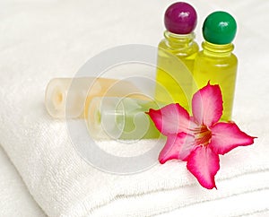 Toiletries and flower on white towel