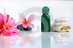 Toiletries with plumeria flower and towel