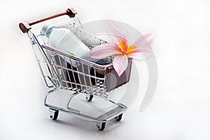 Toiletries with plumeria flower and trolley