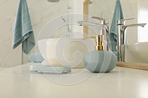 Toiletries and sink near mirror on countertop