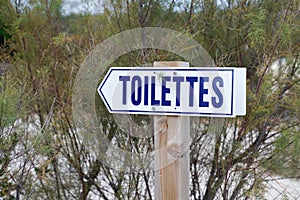 Toilettes french text means Toilets public restroom signs arrow access photo