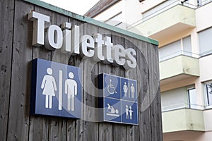Toilettes french text means wc Toilet sign icon on wooden building facade water-closets wall entrance photo