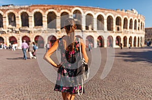 Toirust woman in Verona historical center on square near Arena Verona, Roman amphitheater. Traveler in famous travel destination