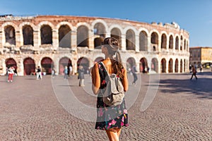 Toirust woman in Verona historical center on square near Arena Verona, Roman amphitheater. Traveler in famous travel destination