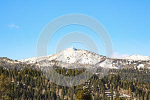 Toiyabe national forest view snowy mountain view sunlit trees around clear sunlit sky background photo
