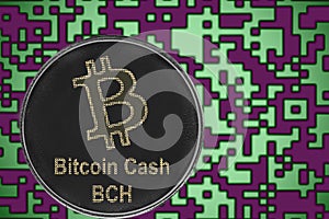 Token BitcoinCash BCH coin cryptocurrency on the background of gold crypto code