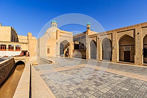 Toki Sarrofon indoor market and channel near it at sunny day, Bukhara, Uzbekistan.