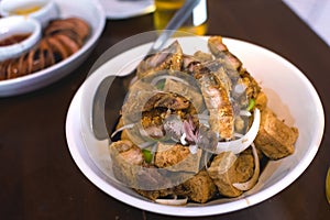 Tokwa\'t Baboy, a popular Filipino appetizer or pulutan served with other dishes at a restaurant or bar