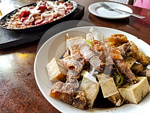 Tokwa`t Baboy and Sizzling Hotdog, popular Filipino appetizers or pulutan served in a restaurant or bar