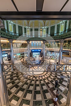 Motion blurred people conmuting and stainless steel columns at Tokyo Station Marunouchi building