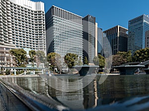 Tokyo cityscape with public park and skyscraper in background.