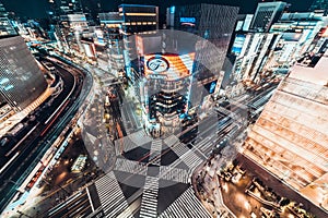 Tokyo, Japan - Jan 13, 2019: Cityscape aerial night view of Ginza zebra crosswalk road intersection with car traffic