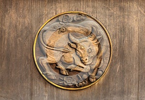 Plum trees and oxen engraving on the wooden door of the Yushima-Tenmangu shrine