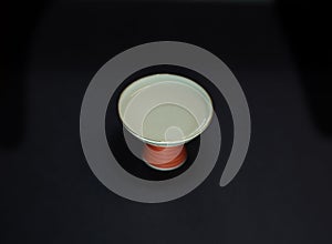 isolated sake cup or sakazuki on black background