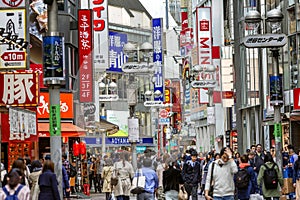 Tokyo, Japan, 04/12/2019: Traffic of people on a busy street with shops and restaurants in the city