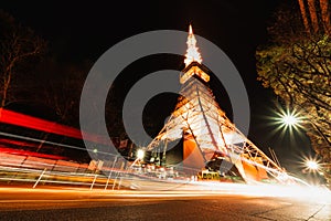 Tokyo tower at night with traffic light trails. Japan iconic symbol, Asia travel destination, Japanese tourism concept