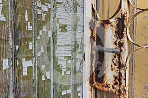 Told door lock and texture of old pine boards with peeling paint