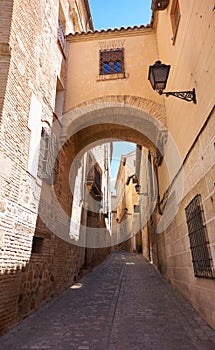 Toledo juderia arch in Spain photo