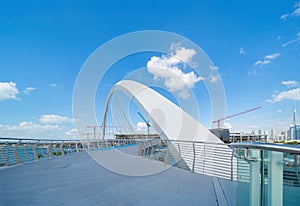 Tolerance bridge. Structure of architecture with lake or river, Dubai Downtown skyline, United Arab Emirates or UAE. Financial