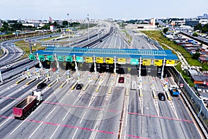 Toll roads on the broad highway. Through the point passes a large number of trucks and cars. Top down view of a