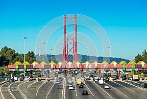 Toll station at the entrance to the 25th April Bridge between Lisbon and Almada, Portugal. Cars passing through pay station