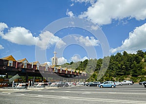 Toll station at the entrance to the 25th April Bridge between Lisbon and Almada, Portugal. Cars passing through pay