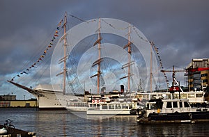 Large impressive sailing ship at the port with many country flags photo