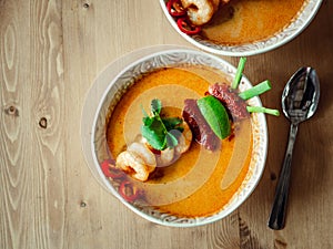 Tom yam kong or Tom yum soup on wooden table