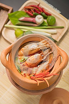 Tom Yum Goong in a clay pot spicy soup traditional thai food cuisine in Thailand on mat wicker background,Tom Yum Kung,Thai Food