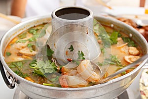 Tom Yum Goong, spicy soup with shrimp in a hot pot.