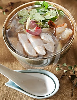 Tom Yum Goong or spicy tom yum soup with shrimp. Thai popular food menu, contained in bowl
