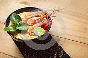 Tom Yum Goong thai food cuisine on wooden