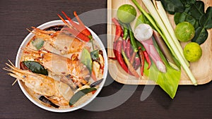 Tom Yum Goong in white bowl, spicy soup traditional thai food cuisine in Thailand on mat wicker background,Tom Yum Kung,Thai Food