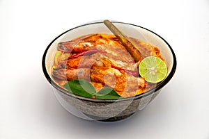 Tom yum kung with rice on white background