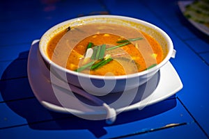 Tom Yum Kung Thai famous soup with shrimp or prawn and coconut milk on in white bowl isolated on table