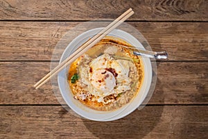 Tom yum noodles with minced pork and fried egg