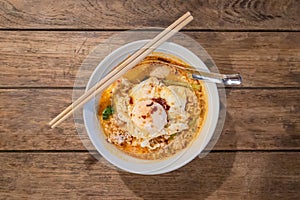 Tom yum noodles with minced pork and fried egg photo