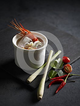 Tom Yum Seafood Soup served in a dish isolated on mat side view on grey background