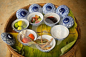 Tom Yum soup ingredients in typical asian blue crockery