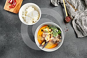 Tom yum soup with spicy seafood. Grey bowl on dark slate table. Thai, asian, authentic food concept