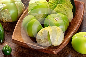 Tomatillos, green tomatoes, Mexican cuisine ingredient on a wooden background