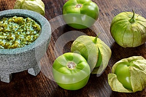 Tomatillos, green tomatoes, with salsa verde, green sauce, in a molcajete