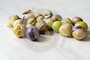 Tomatillos, green tomatoes, with salsa verde, green sauce, in a molcajete, traditional Mexican mortar