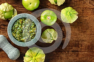 Tomatillos, green tomatoes, with salsa verde, green sauce, in a molcajete