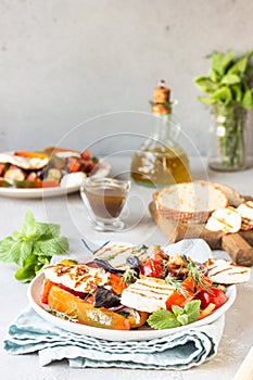 Tomato, baked pepper and onion salad with grilled haloumi cheese halloumi.
