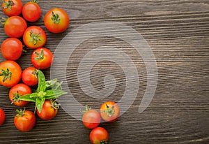 Tomato with basil on wood table