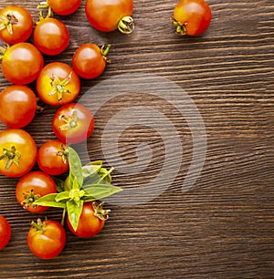 Tomato with basil on wood table