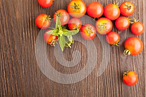 Tomato with basil on wood table