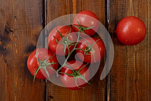 Tomato on a brown wooden background, top view, text space, fresh vegetables