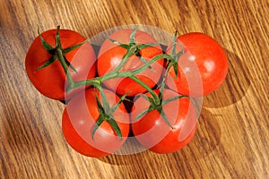 Tomato, bunch of vegetables on a wooden table, view from above